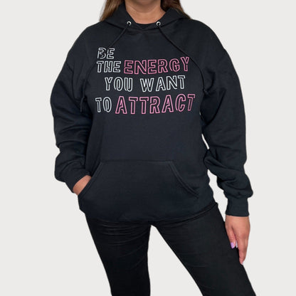 Be The Energy You Want To Attract Black Sweatshirt Hoodie With White/Pink Design