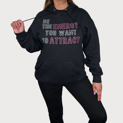 Be The Energy You Want To Attract Black Sweatshirt Hoodie With White/Pink Design