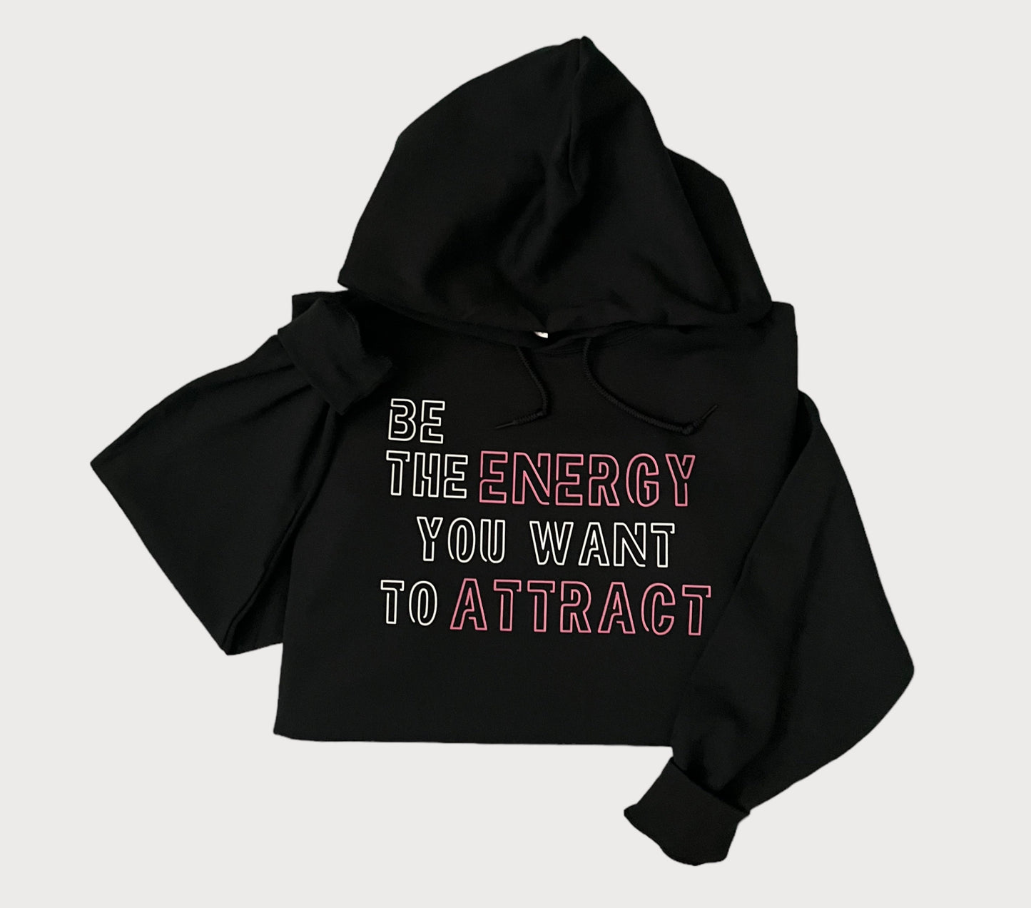 Be The Energy You Want To Attract Black Sweatshirt Hoodie With White/Pink Design