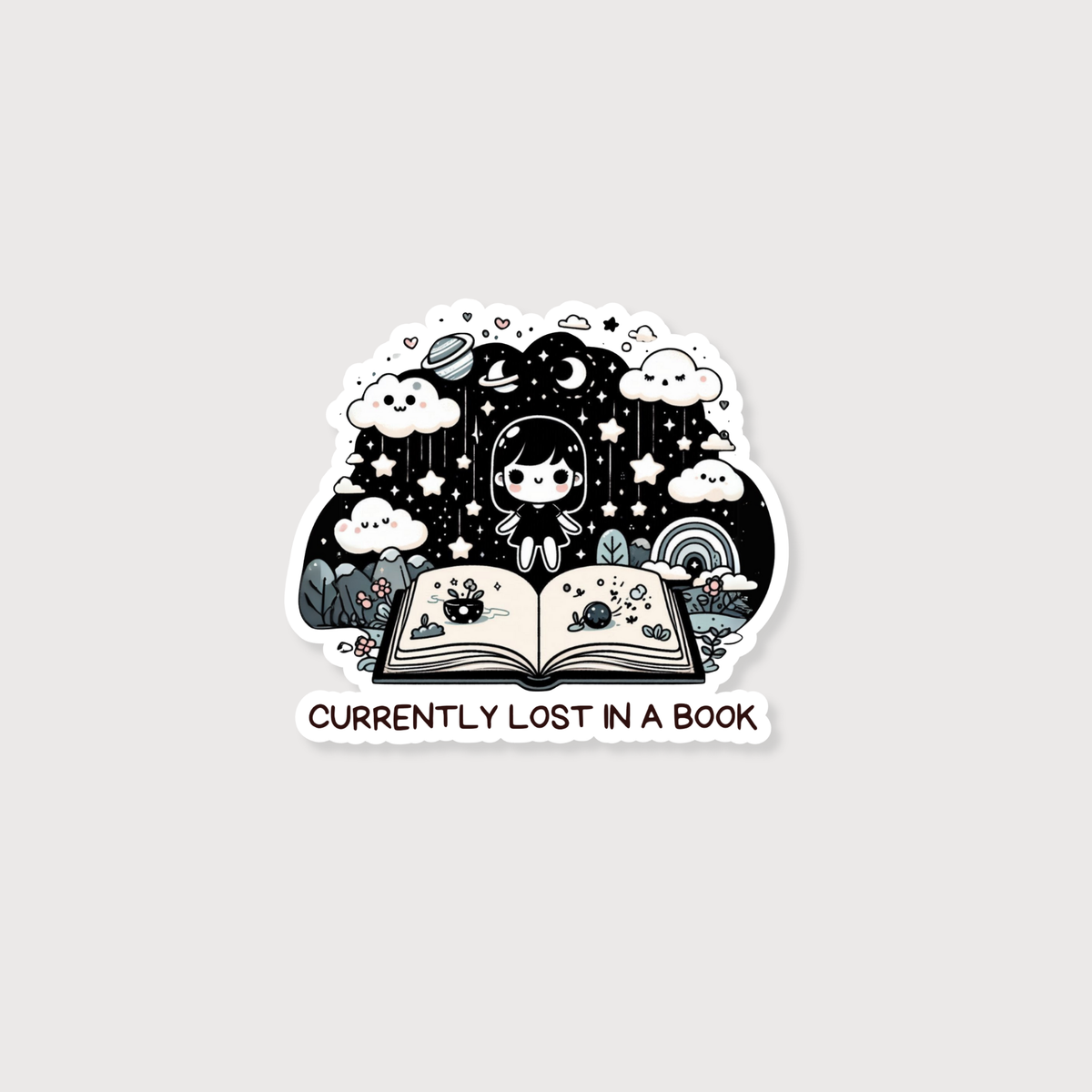 A die-cut sticker featuring a person sitting inside an open book surrounded by stars, clouds, rain, and a rainbow, with the text 'CURRENTLY LOST IN A BOOK' below, shown on a light gray background.