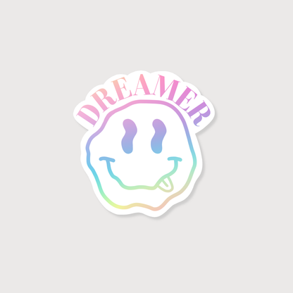 Sticker with smiley face design and 'DREAMER' text on a light gray background