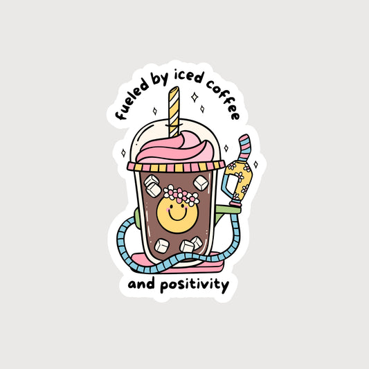 Iced coffee with a colorful gas pump handle with the words Fueled By Iced Coffee And Positivity 