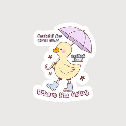 Yellow Duck with a Purple umbrella and Blue boots with the quote Grateful For Where I'm At Excited For Where I'm Going Sticker