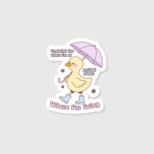 Yellow Duck with a Purple umbrella and Blue boots with the quote Grateful For Where I'm At Excited For Where I'm Going Sticker