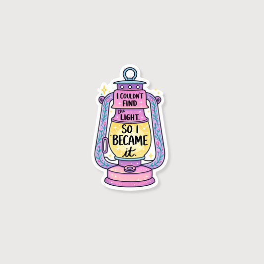 A die-cut sticker featuring a whimsical lantern illustration with the text 'I COULDN'T FIND LIGHT. SO I BECAME it.