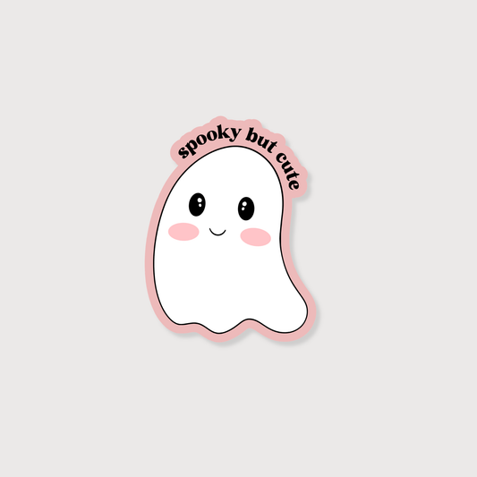 A cute cartoon ghost sticker with the text 'spooky but cute' in black script along a pink outline, shown on a light gray background.