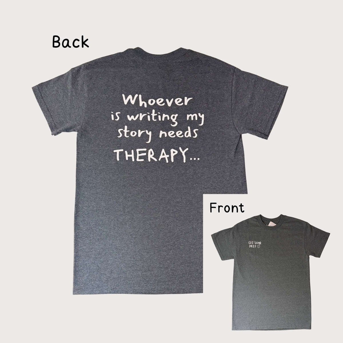A dark heather gray t-shirt shown from both front and back on a light gray background. The back of the shirt features large white text that reads 'Whoever is writing my story needs THERAPY.