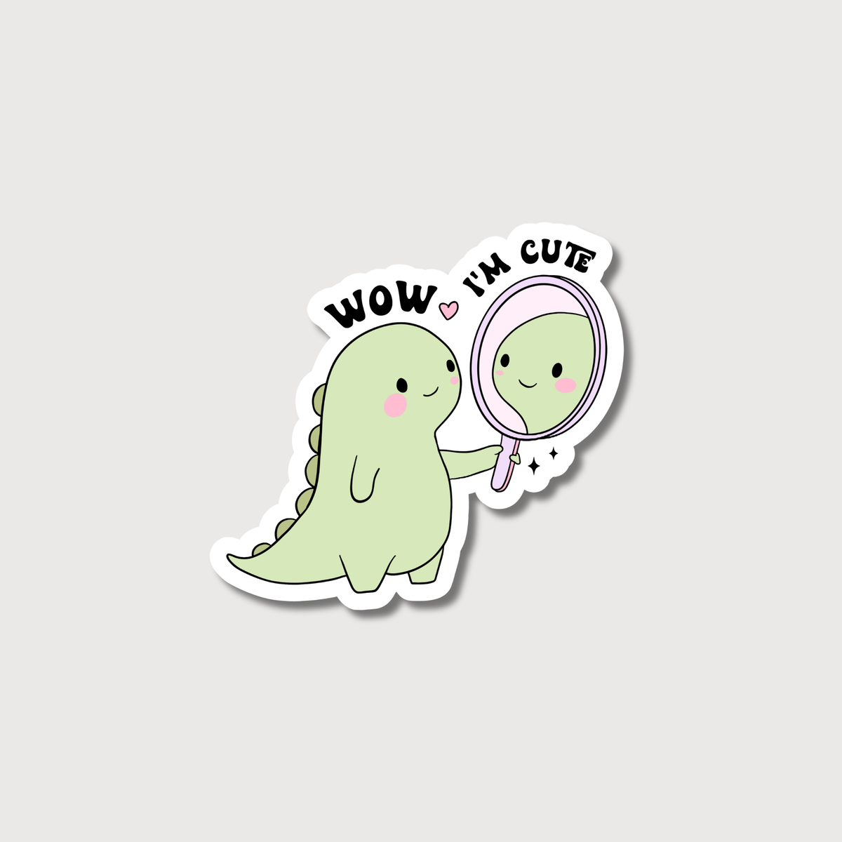 Sticker of a green dinosaur looking at itself in a mirror with 'Wow, I'm cute' text on a light gray background.