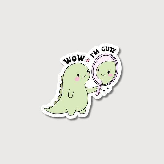 Sticker of a green dinosaur looking at itself in a mirror with 'Wow, I'm cute' text on a light gray background.