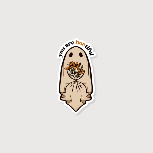 Sticker with a ghost holding flowers and 'you are bootiful' text on a light gray background
